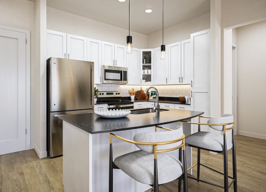 a kitchen with a center island with three stools